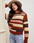 Woman wearing a striped sweater and hat against a neutral background