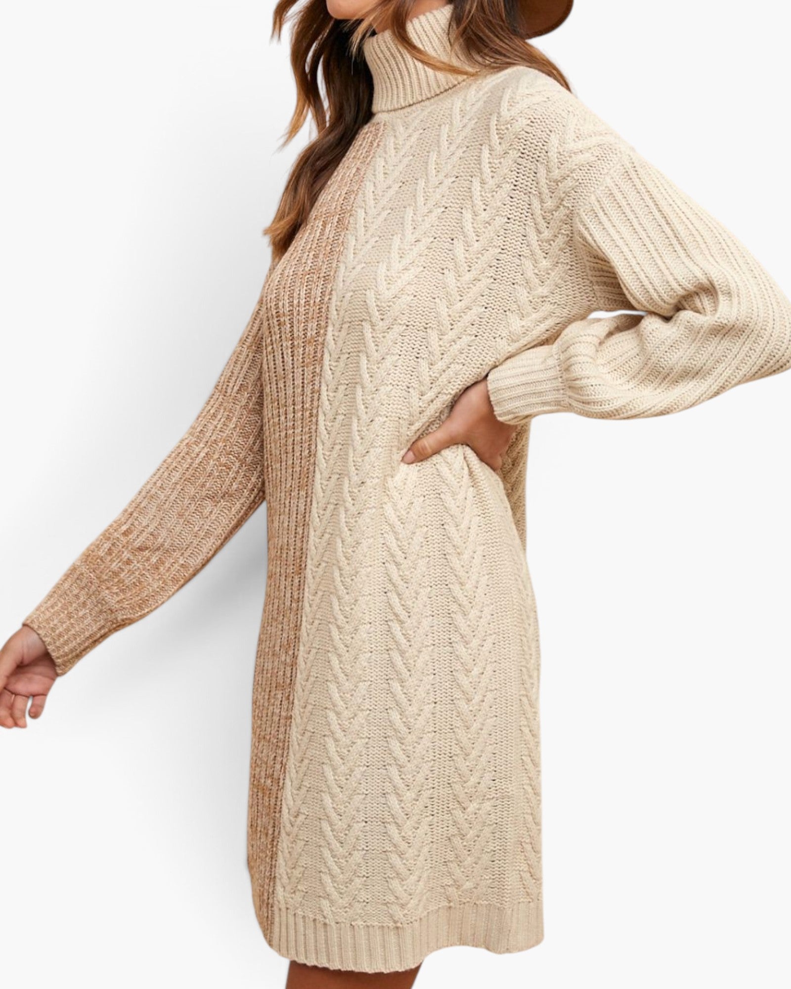 A woman wearing a chunky knit turtleneck sweater dress in cream with a textured cable pattern, shown from the side against a plain white background.