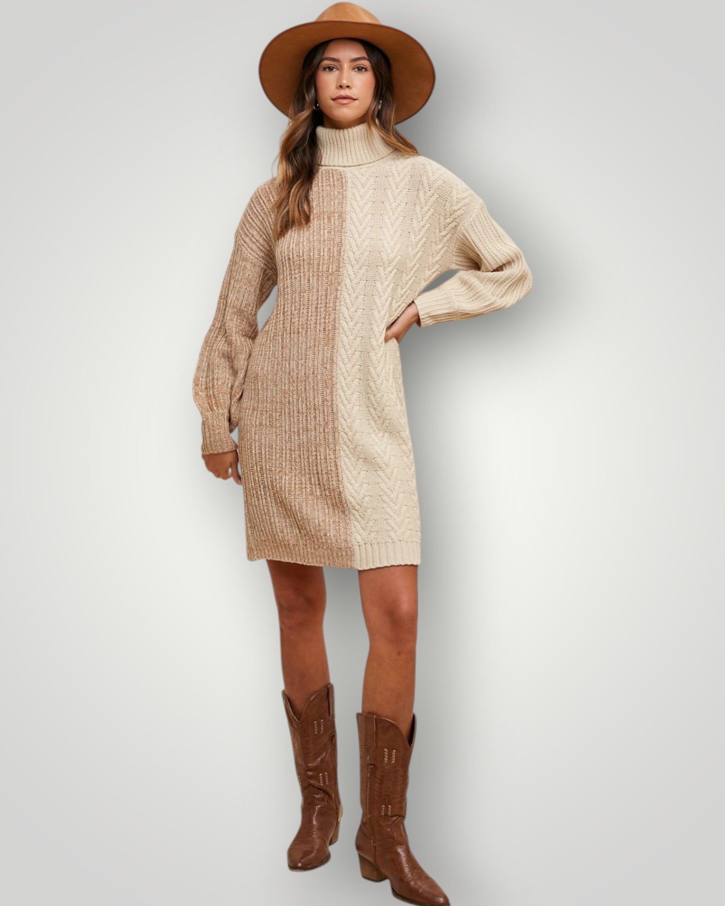 Woman wearing a beige sweater dress, brown boots, and a hat on a light gray background