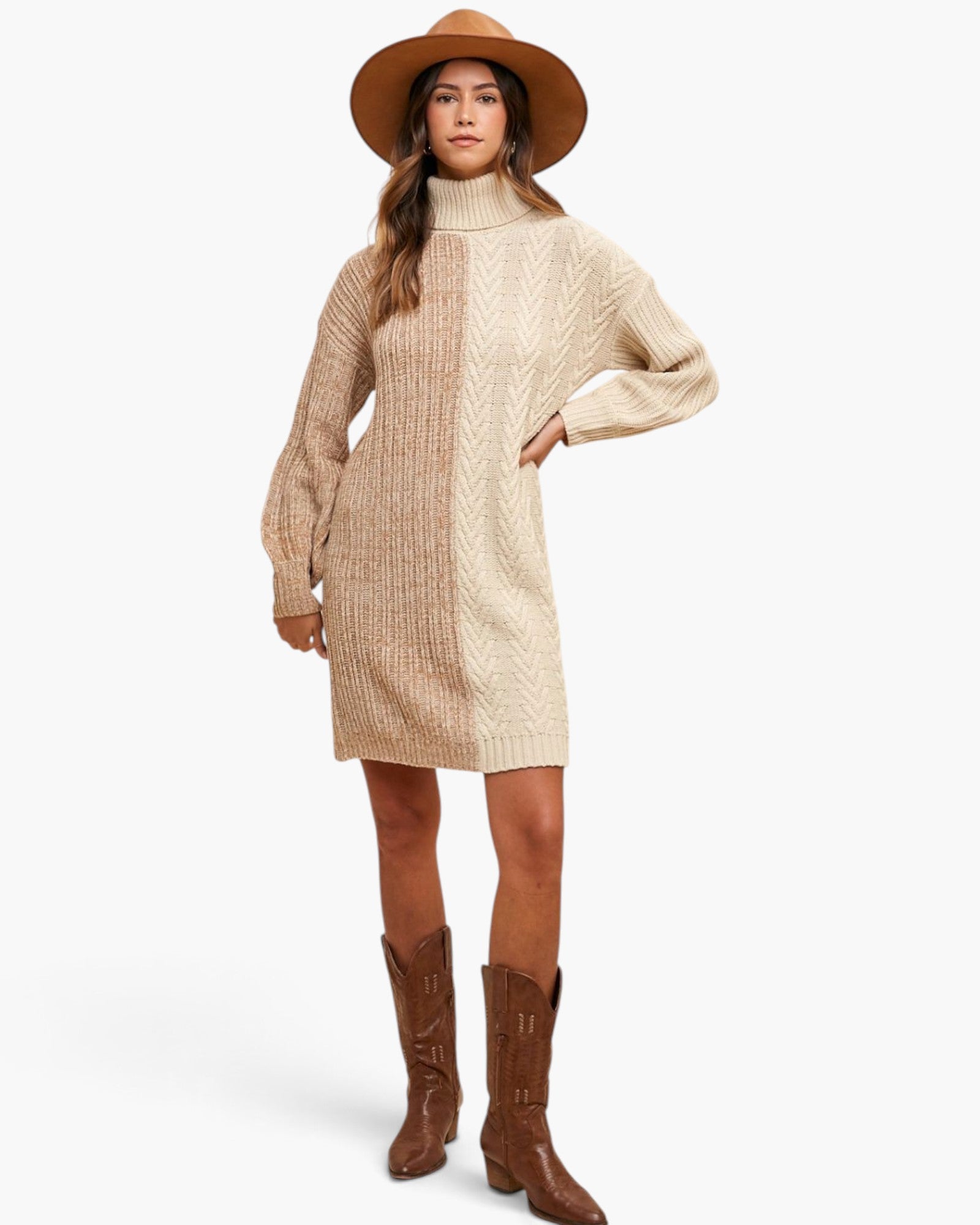 A woman modeling a beige cable-knit turtleneck sweater dress with long sleeves, paired with brown cowboy boots and a wide-brimmed brown hat, against a plain white studio background.