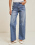 Person wearing blue wide-leg jeans on a plain background