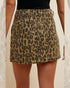 Leopard print skirt worn by a person on a neutral background