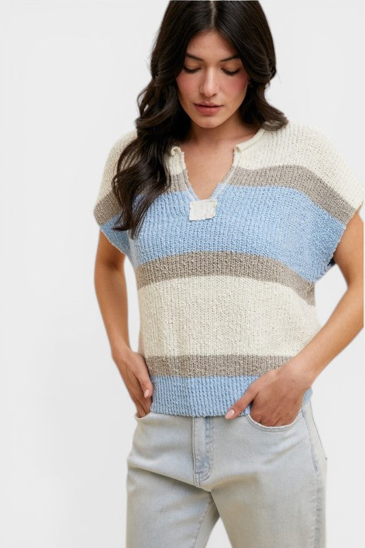 Woman wearing a colorful striped sweater on a white background