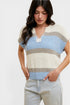 Woman wearing a colorful striped sweater on a white background