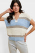 Woman wearing a striped sleeveless sweater against a white background