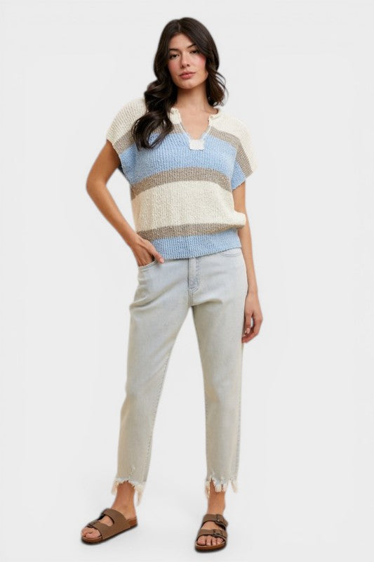 Woman wearing a striped sweater and jeans on a white background