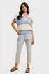 Woman wearing a striped sweater and jeans on a white background