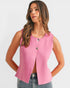 Woman wearing a pink sleeveless top with buttons on a white background