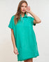 Woman wearing a teal dress against a plain background