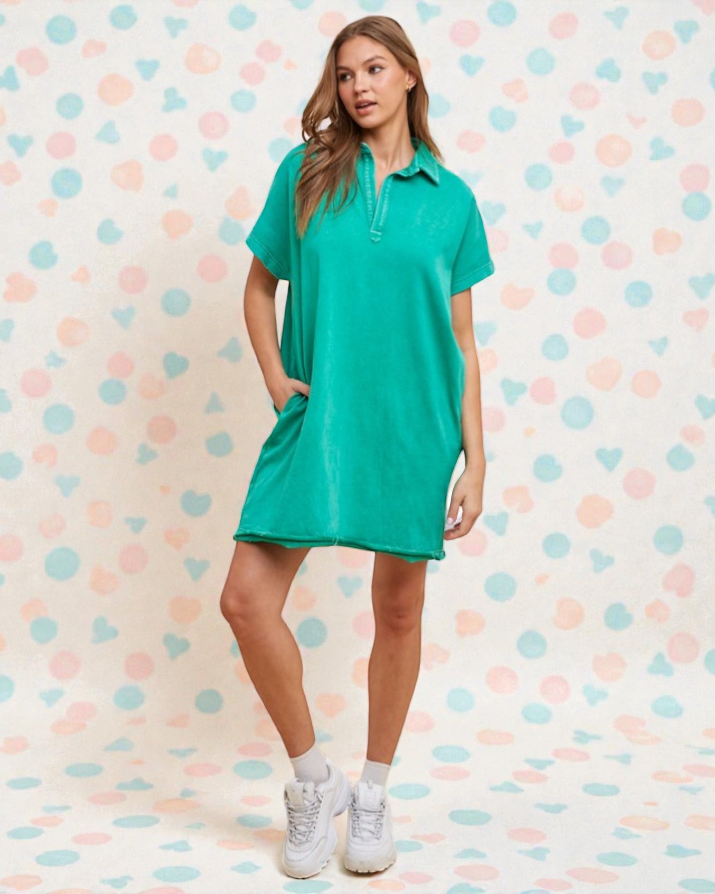 Woman wearing a green dress against a polka dot background