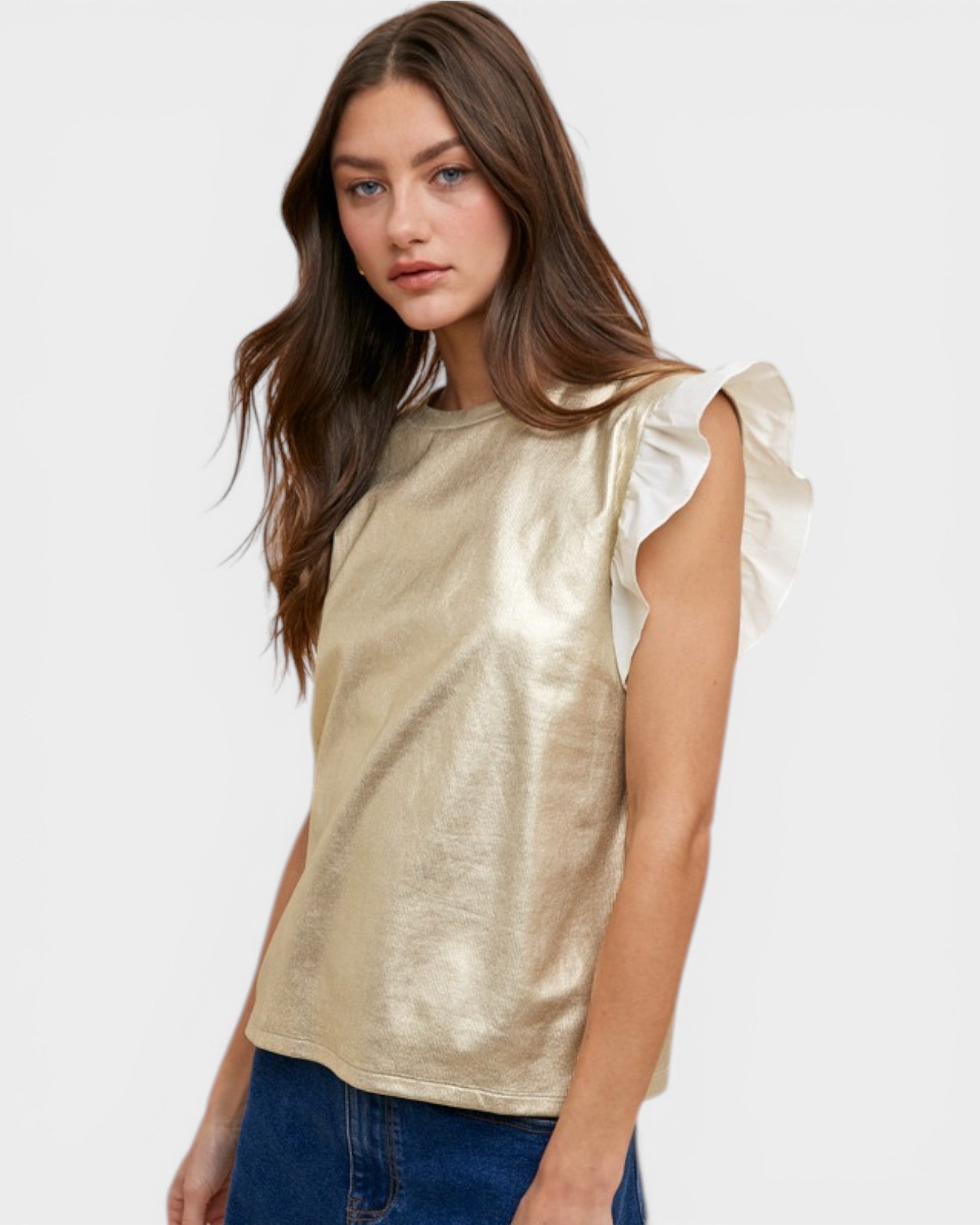Woman wearing a gold metallic top with white ruffled sleeves on a white background