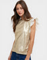Woman wearing a gold metallic top with white ruffled sleeves on a white background