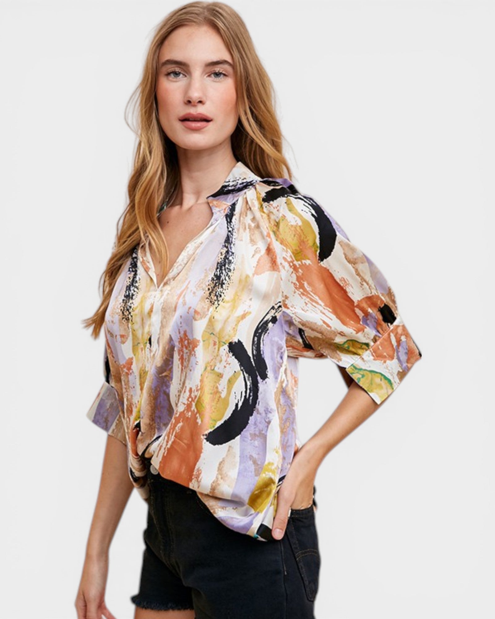 Woman wearing a colorful abstract patterned shirt on a white background