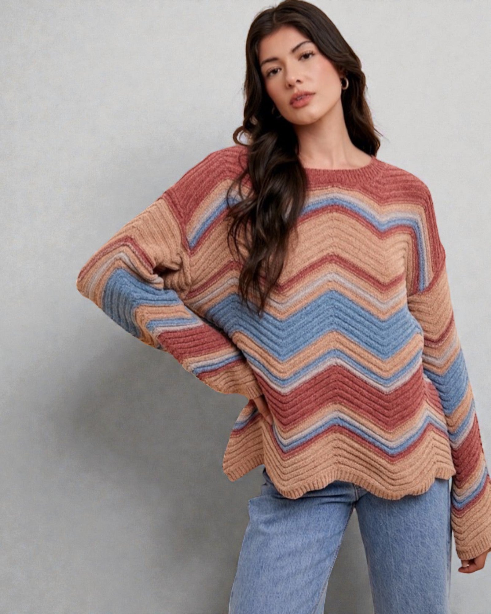 Woman wearing a colorful striped sweater against a plain background
