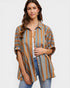 Woman wearing a striped shirt with a plain background
