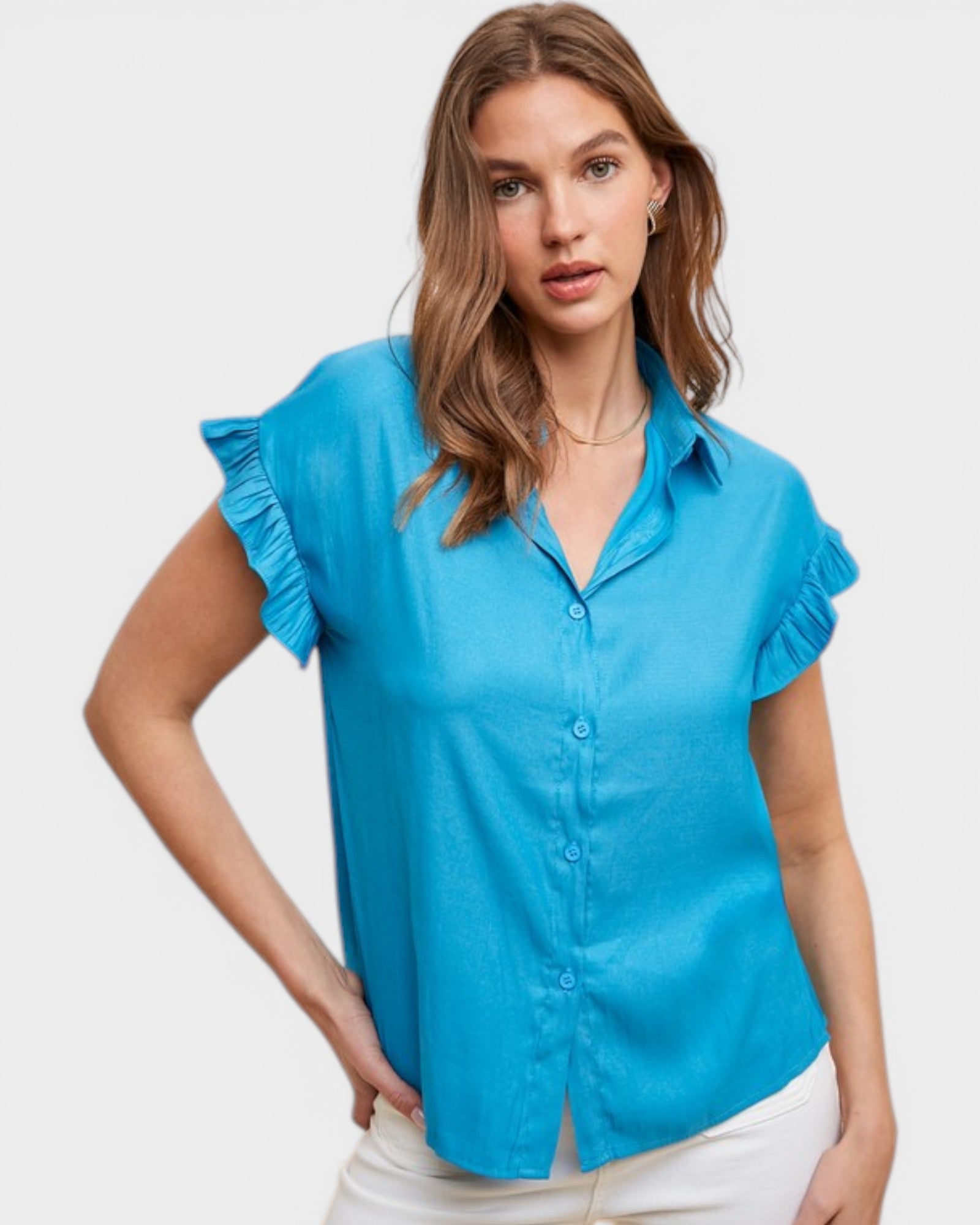 Woman wearing a blue blouse with ruffled sleeves on a white background