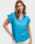 Woman wearing a blue blouse with ruffled sleeves on a white background