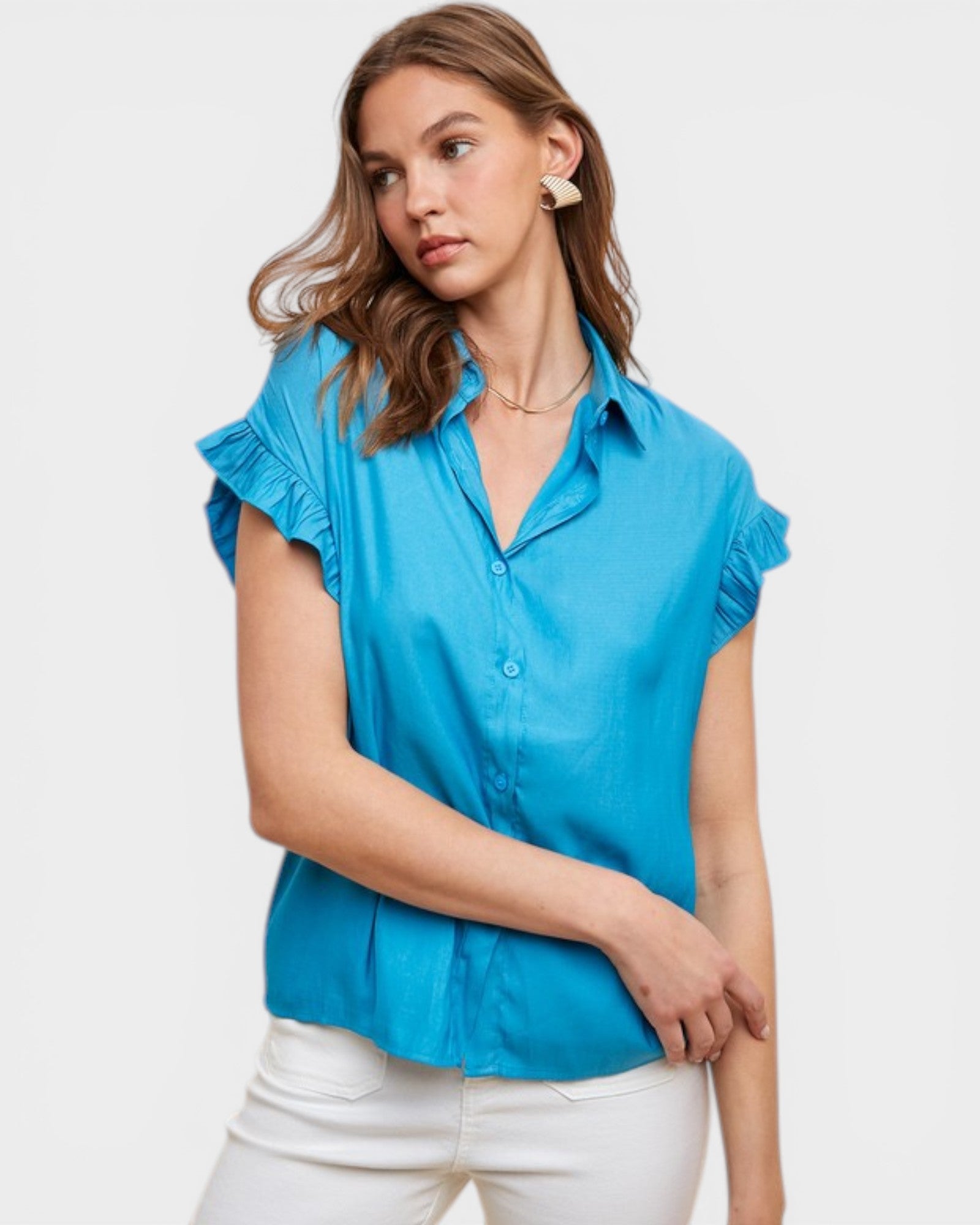 Woman wearing a blue blouse with ruffled sleeves on a white background