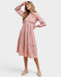 Woman wearing a pink dress on a white background