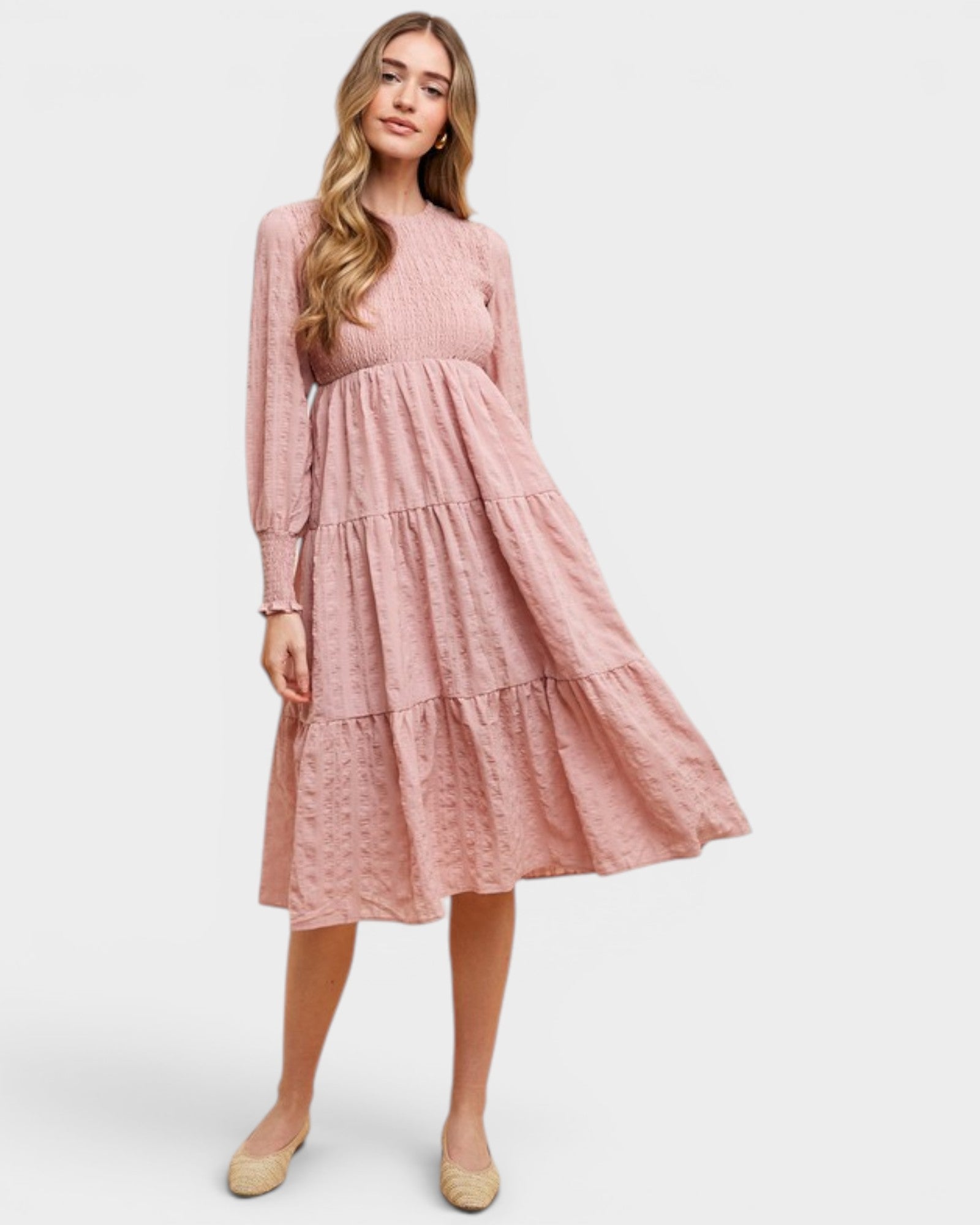 Woman wearing a pink dress on a white background