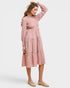 Woman wearing a pink dress on a white background