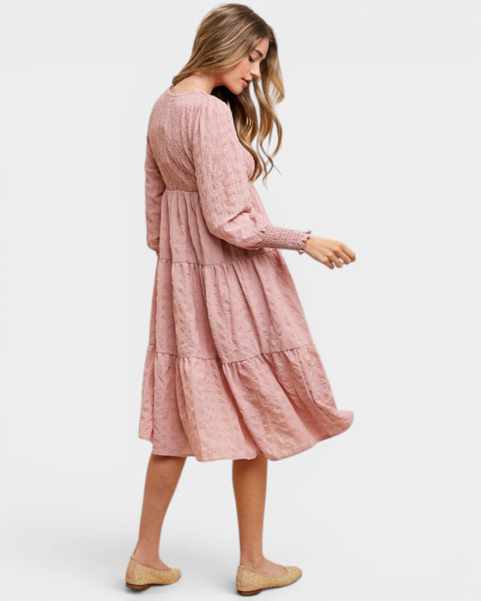 Woman wearing a pink dress on a white background