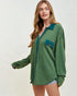Woman wearing a green shirt with a pocket on a white background