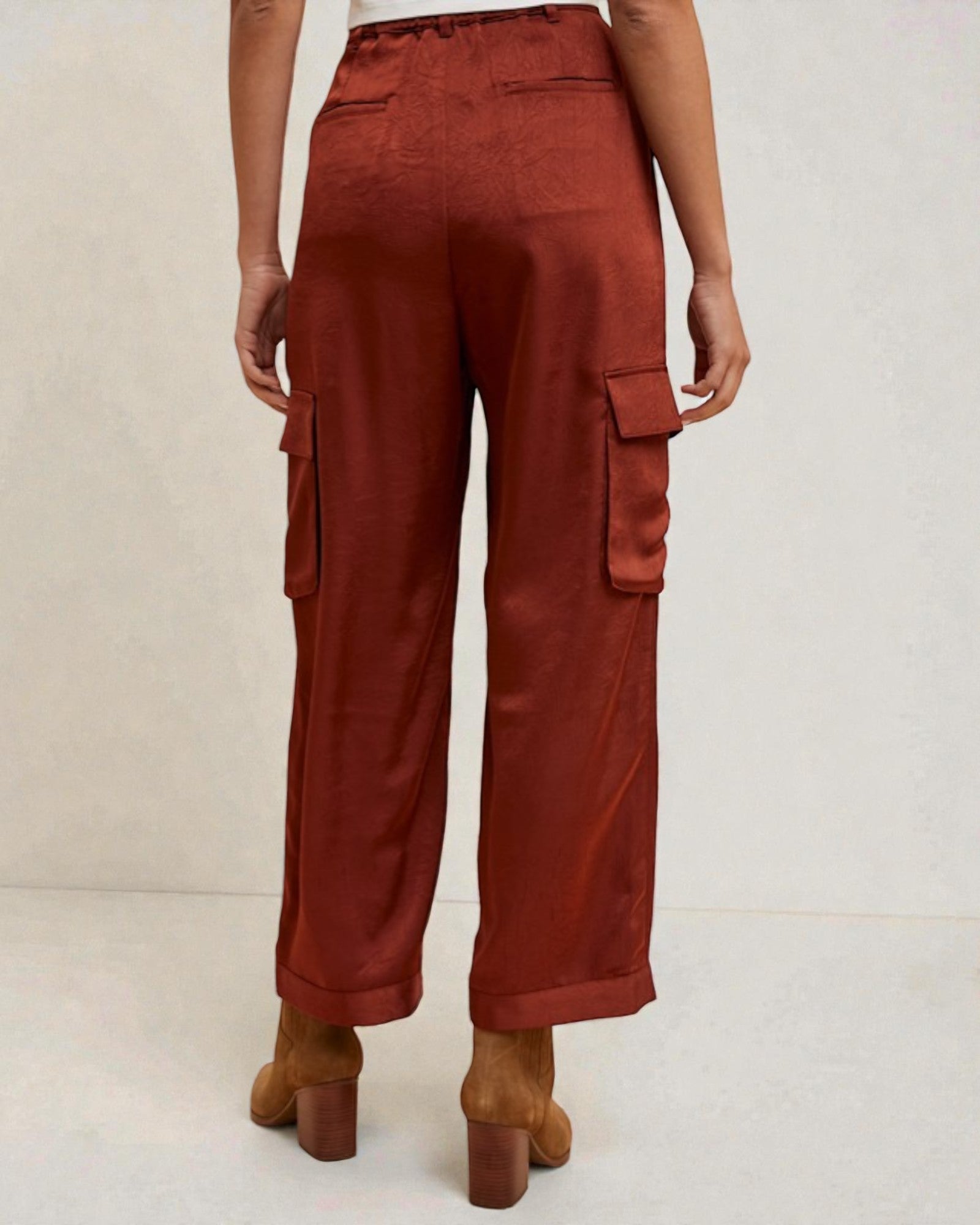 Brown cargo pants worn by a person on a white background