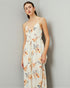 Woman wearing a floral dress against a plain background