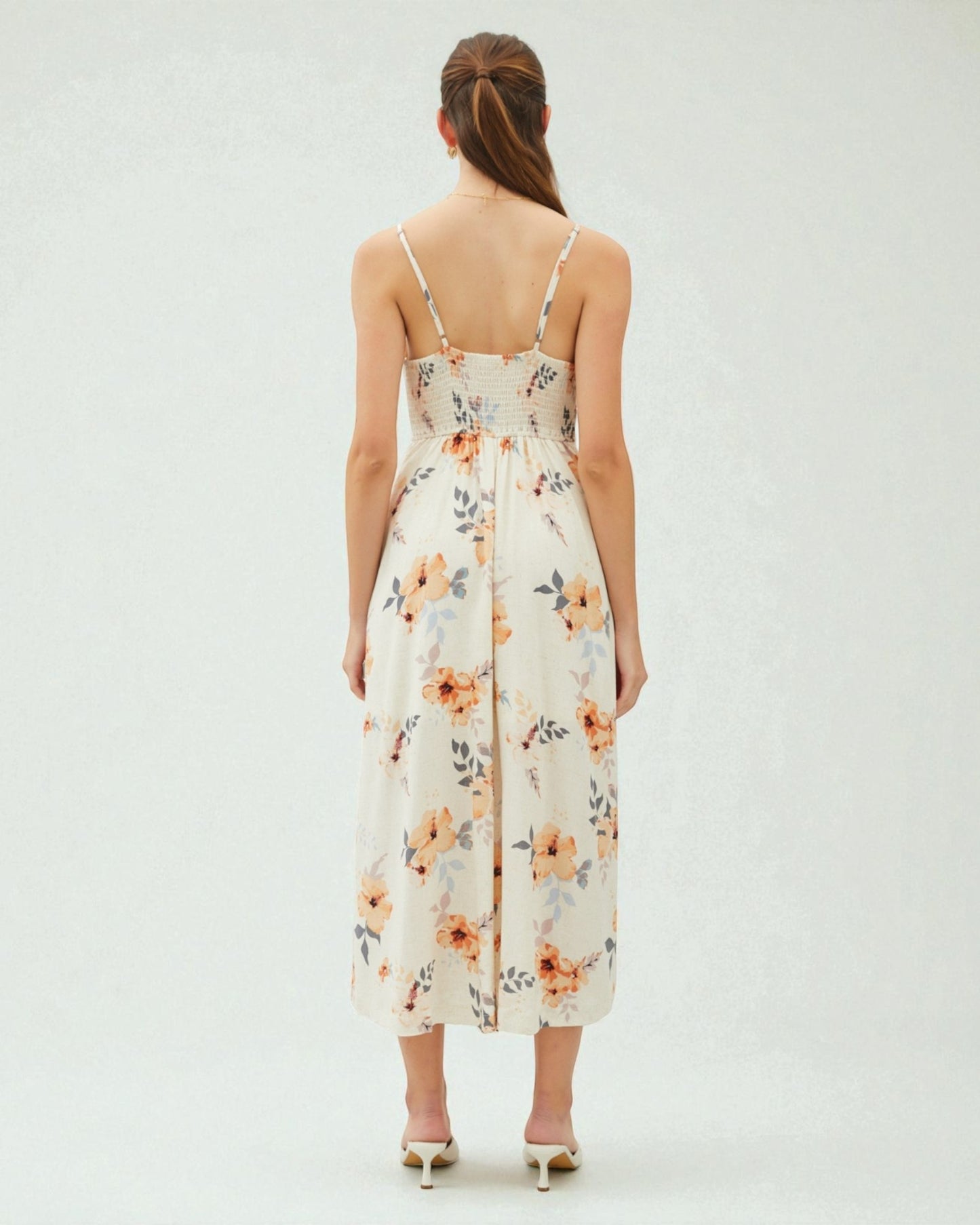 Woman wearing a floral dress on a white background