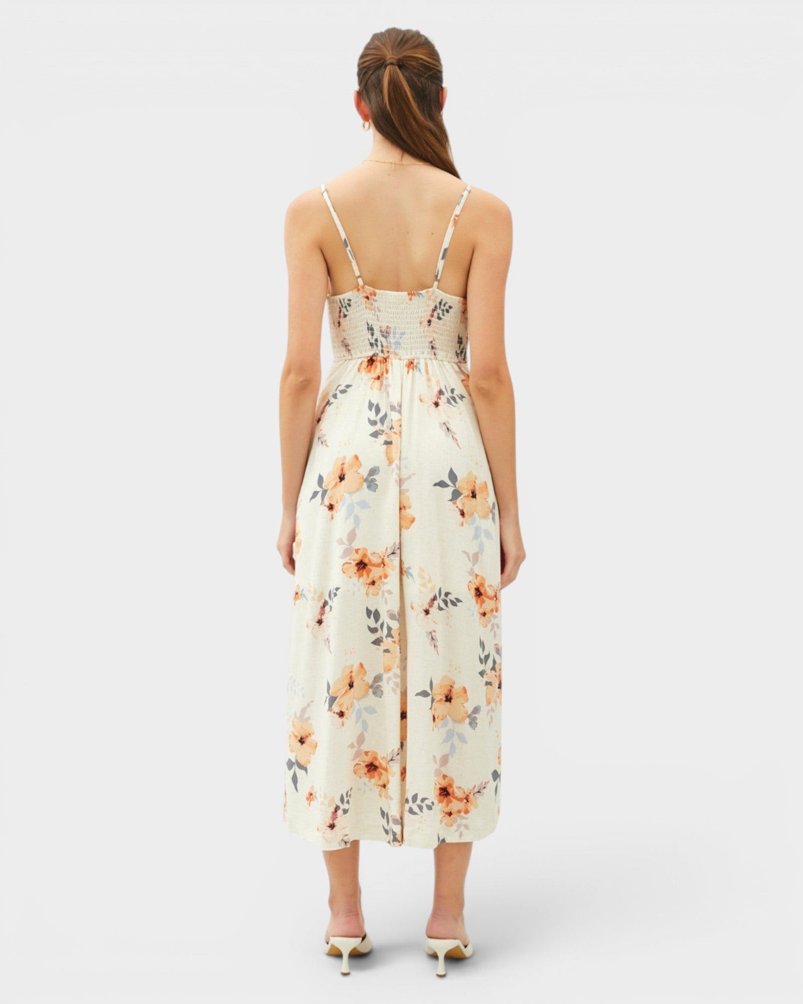 Woman wearing a floral dress on a white background