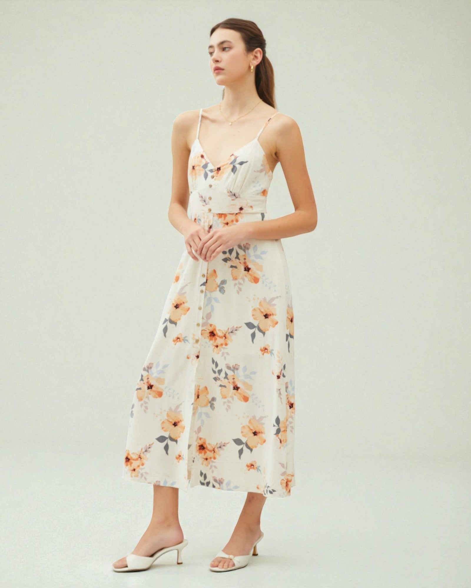 Woman wearing a floral dress on a plain background