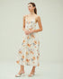 Woman wearing a floral dress on a plain background