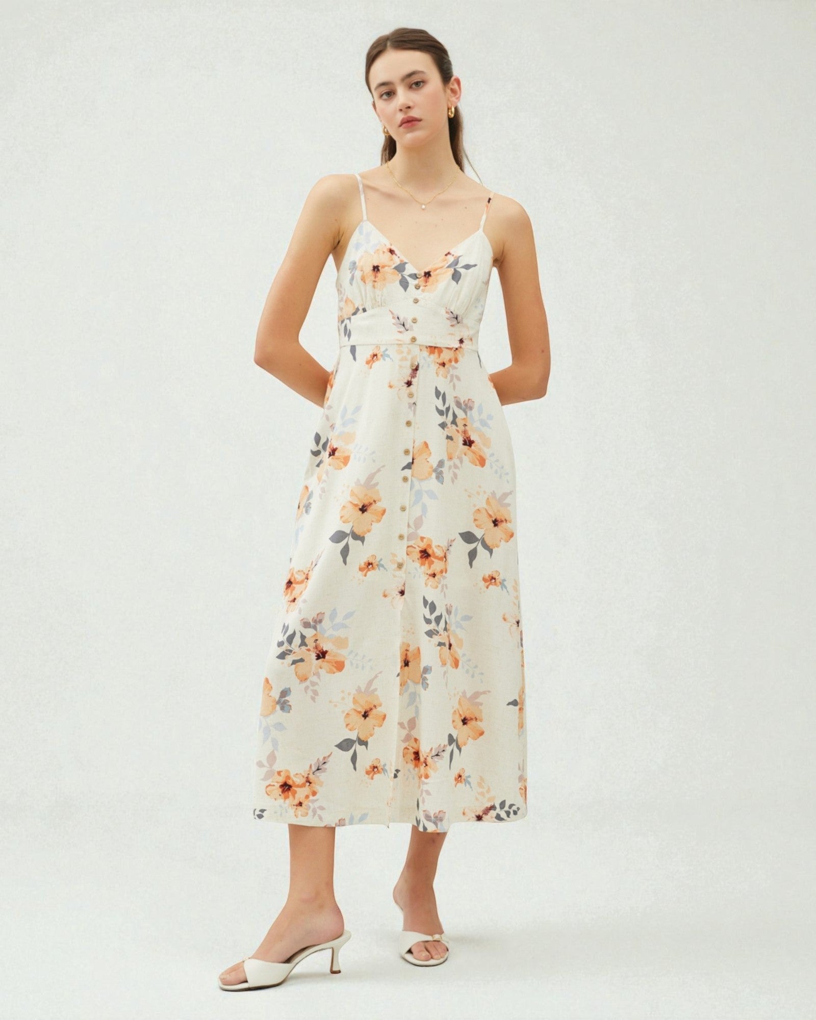 Woman wearing a floral dress on a white background
