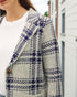 Plaid patterned coat with a blurred background