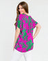 Woman wearing a pink and green patterned blouse on a white background