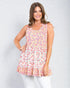 Woman wearing a floral sleeveless top on a white background