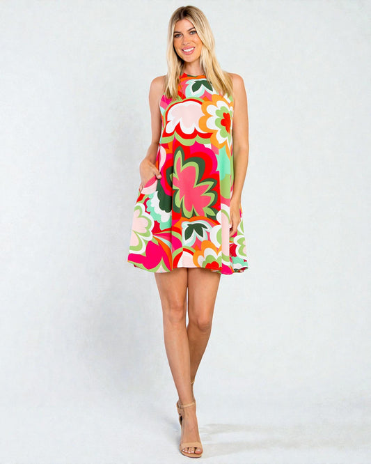 Woman wearing a colorful floral dress on a white background