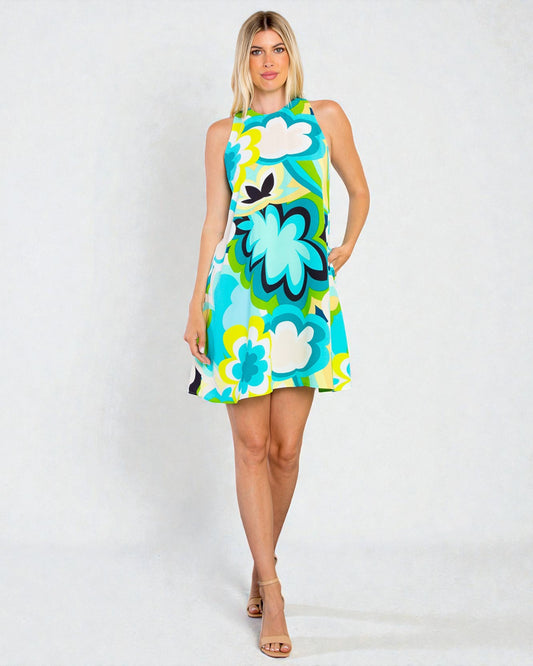 Woman wearing a colorful floral dress on a white background