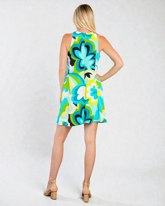 Woman wearing a colorful floral dress on a white background