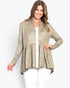 A woman modeling a beige and brown leopard-print cardigan with a peplum waist over a white top and white pants, set against a plain white studio background.