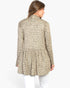 A woman shown from the back wearing a beige and olive green leopard print long-sleeve tunic top with a gathered waist, paired with white pants, against a plain white background.