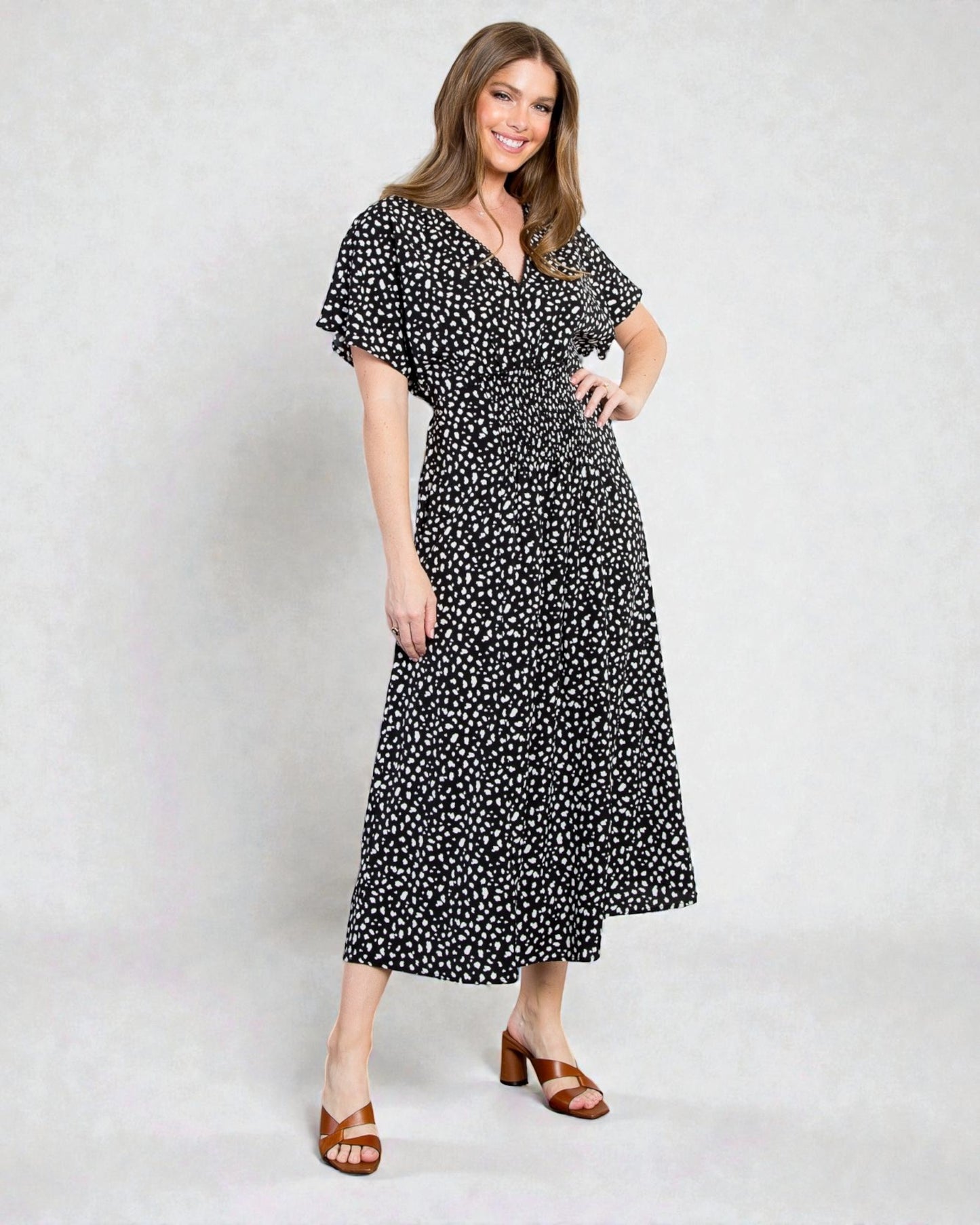 Woman wearing a black floral dress on a white background