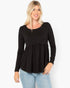 A woman modeling a black long-sleeve peplum top with a scoop neckline, paired with light blue jeans, against a plain white background.