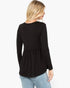 A woman shown from the back wearing a black long-sleeve ribbed knit top with a peplum waist, paired with light blue jeans, against a plain white background.
