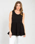 Woman wearing a black sleeveless top with a white background