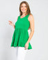 Woman wearing a green sleeveless top against a white background