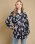 Woman wearing a black and white leopard print shirt against a beige background