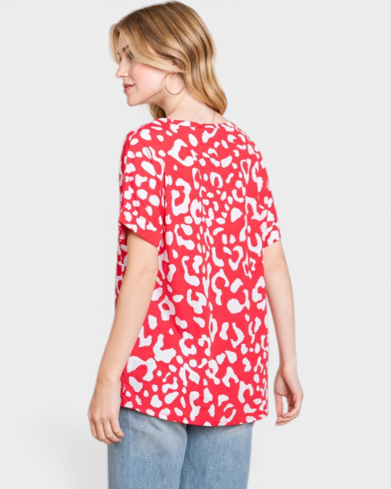 Woman wearing a red and white patterned top on a white background