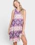 Woman wearing a purple patterned dress on a white background